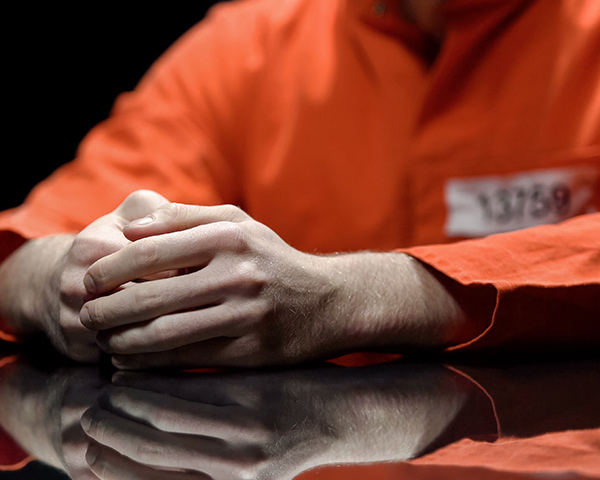 man with sitting with criminal suit 