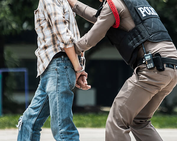 cops taking hand cuffed man