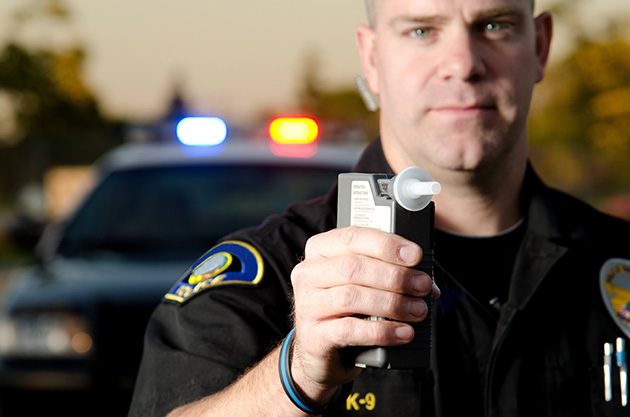 Police man with Breathalyzer in hand