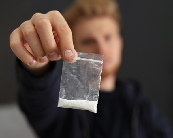 man showing drugs in his possession 