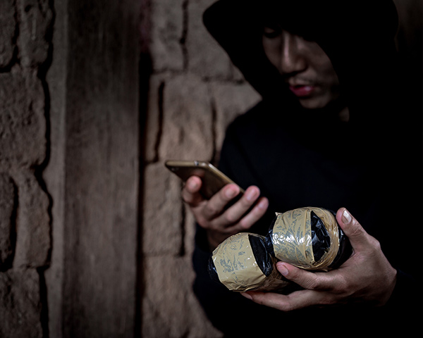 man with drugs packets 