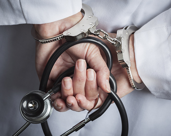 handcuffed with stethoscope in hand